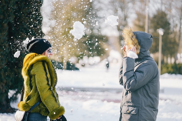 happy couple walking through the park on a sunny winter day