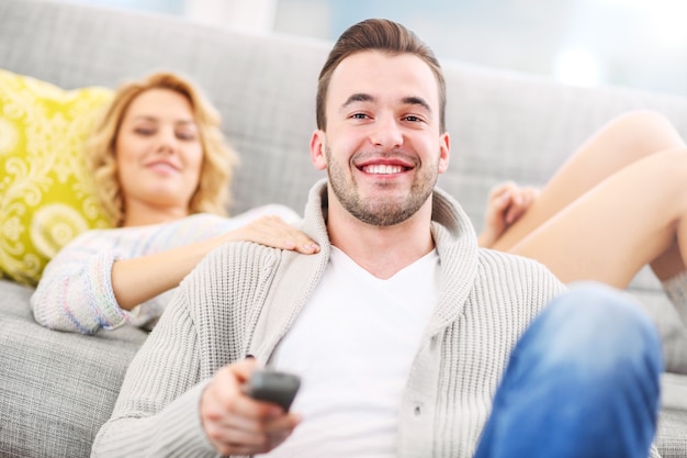 happy couple watching tv at home