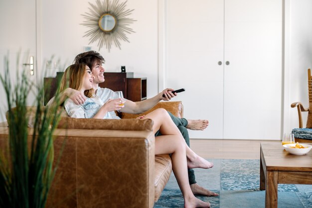 Happy couple watching tv