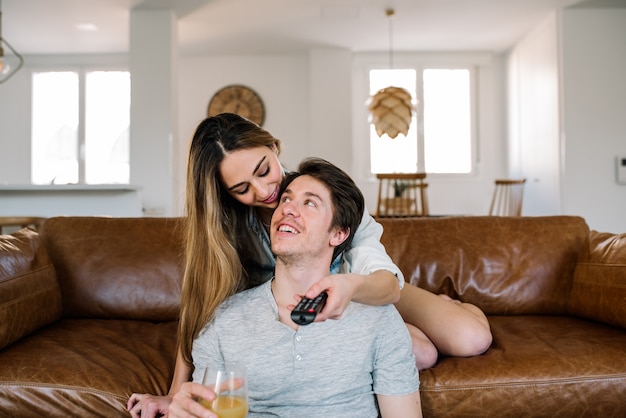 Happy couple watching tv