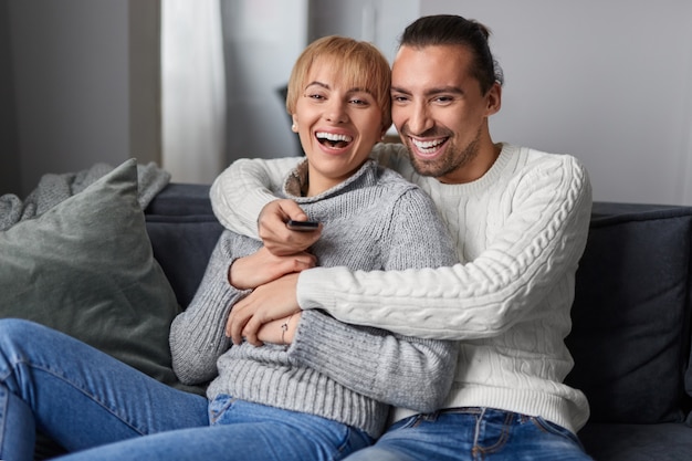 Happy couple watching TV