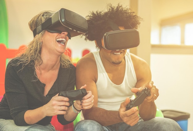 Photo happy couple wearing virtual reality simulator while playing video game at home