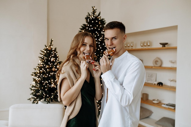 happy couple in white room with Christmas decorations