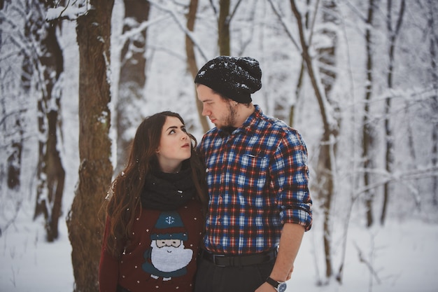 Happy couple in the winter forest