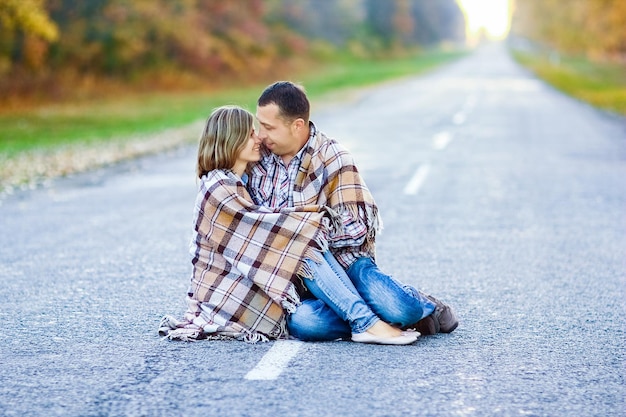 A Happy couple with book on travel on road in park