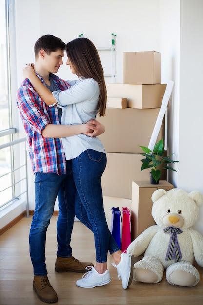 Happy couple with boxes moving to new home