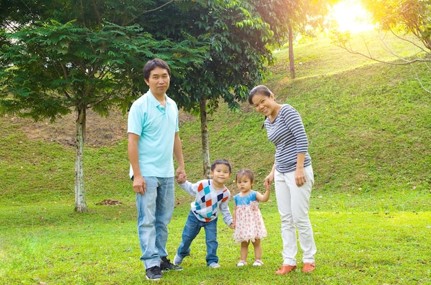 Happy couple with children standing in park