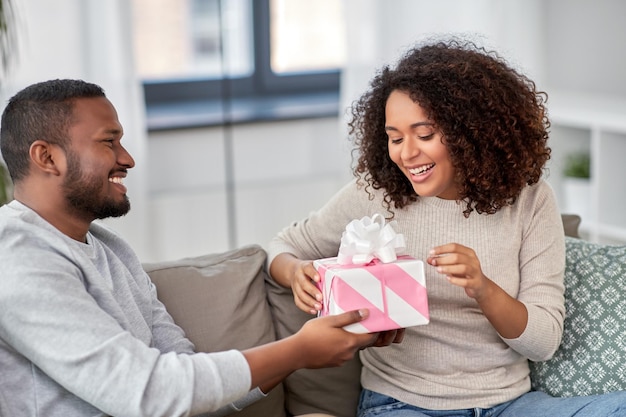 happy couple with gift at home