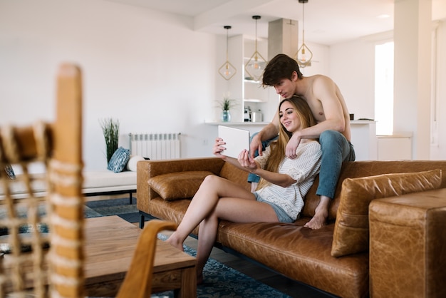 Happy couple with tablet