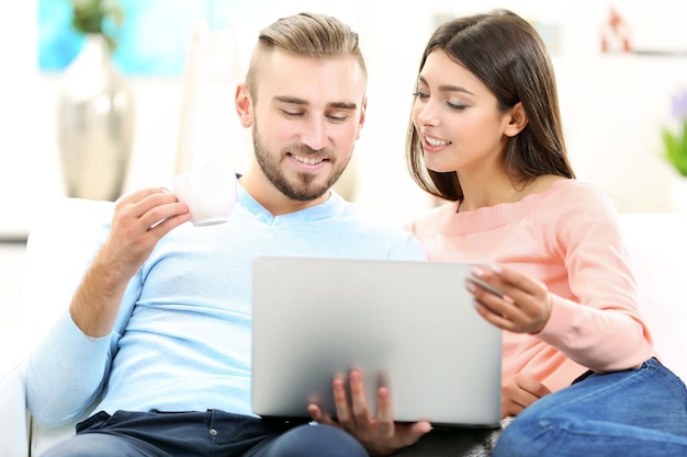 Happy couple working on laptop in a room