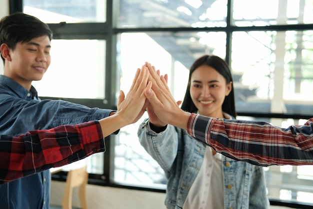 Photo happy coworker giving high-five in office