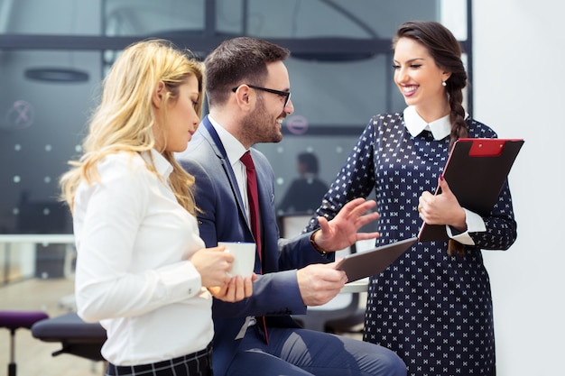 Happy coworkers are chatting after a team meeting.