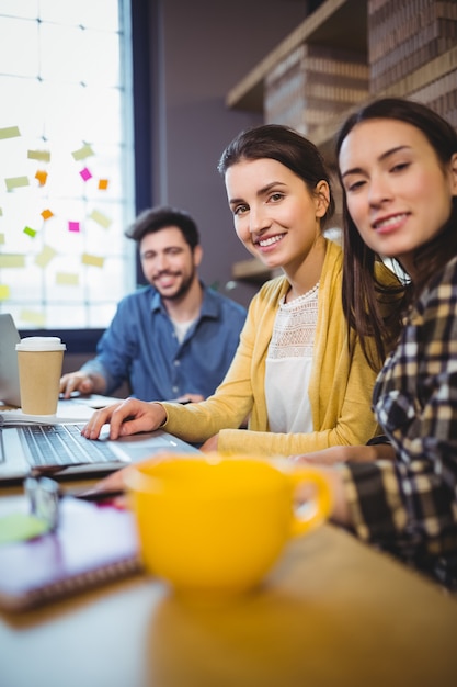 Happy coworkers working at desk