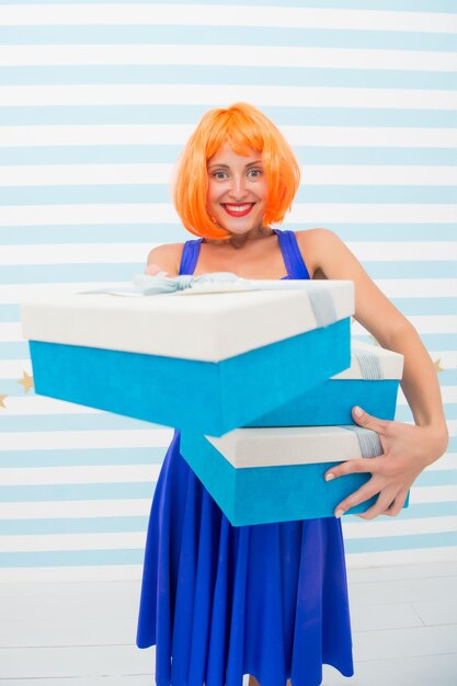 Happy crazy girl with presents. boxing day concept. birthday or christmas present box. its a great offer. big sale shopping with happy crazy girl. Choosing the best. Shopaholic. After shopping.