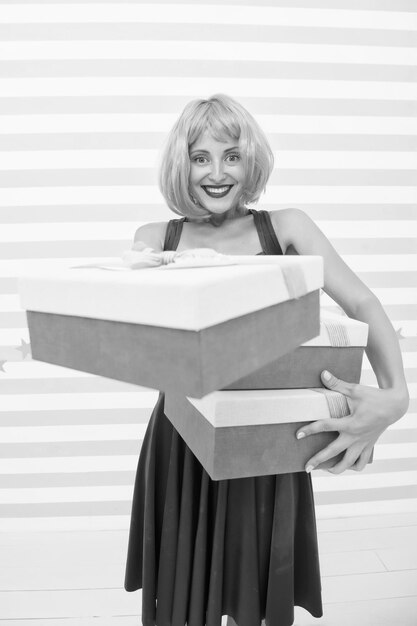 Happy crazy girl with presents boxing day concept birthday or christmas present box its a great offer big sale shopping with happy crazy girl Choosing the best Shopaholic After shopping