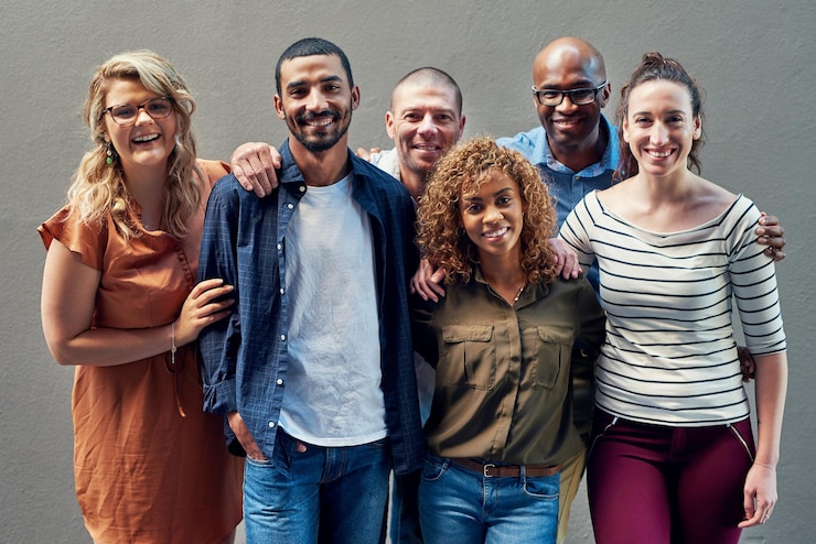 Photo happy creative people portrait and diversity with unity for company growth together on a wall background group of diverse business employees team or designers with smile for startup or about us