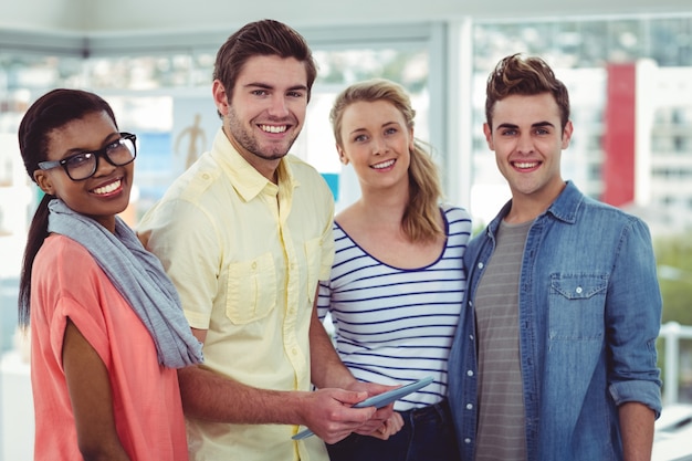 Happy creative team using a tablet pc