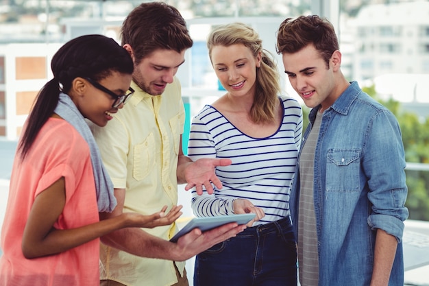 Happy creative team using a tablet pc