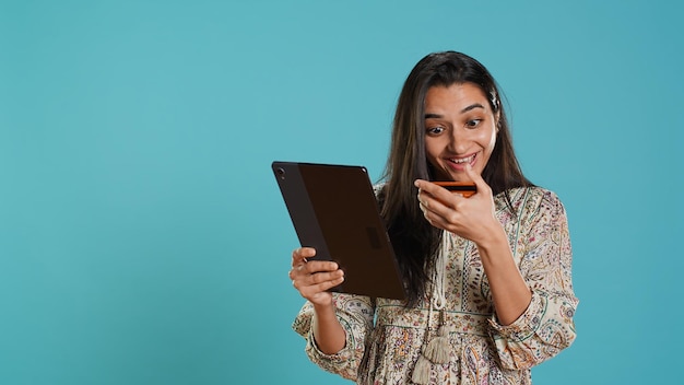 Happy customer does internet shopping on tablet