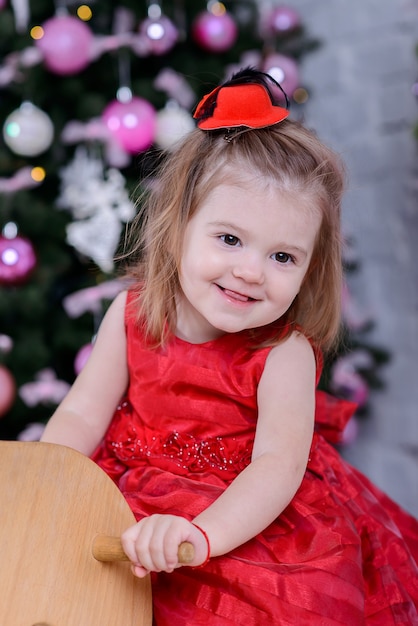 Happy Cute baby girl near Christmas tree