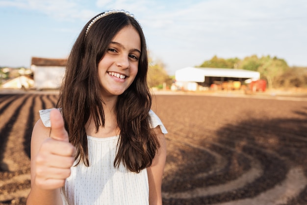 Happy cute child girl on the coffee farm background. Kid on the farm. Latin people.