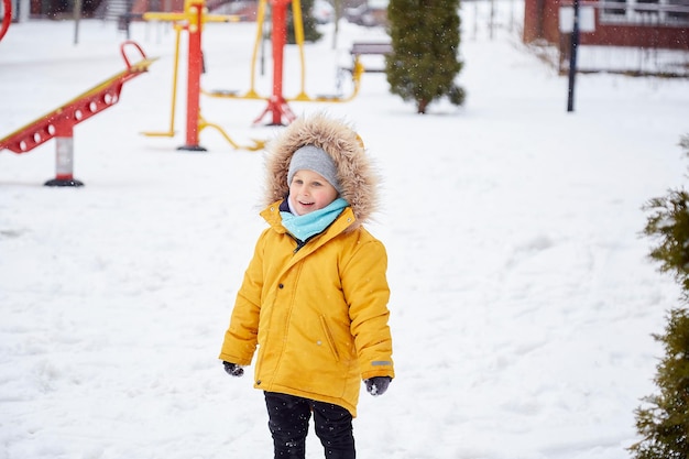 Happy cute child having fun in the snow Enjoying winter fun outside Winter vacations High quality photo