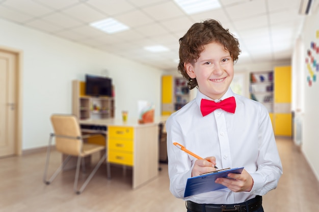 Ragazzo intelligente sveglio felice a scuola. prima volta a scuola. di nuovo a scuola.