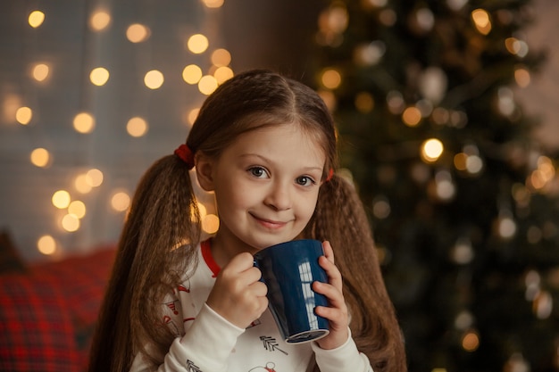 Happy cute girl drinking tea