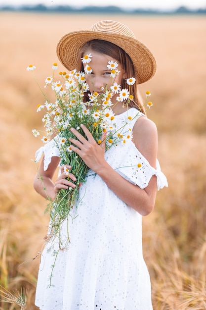 Happy cute girl in wheat field outdoors