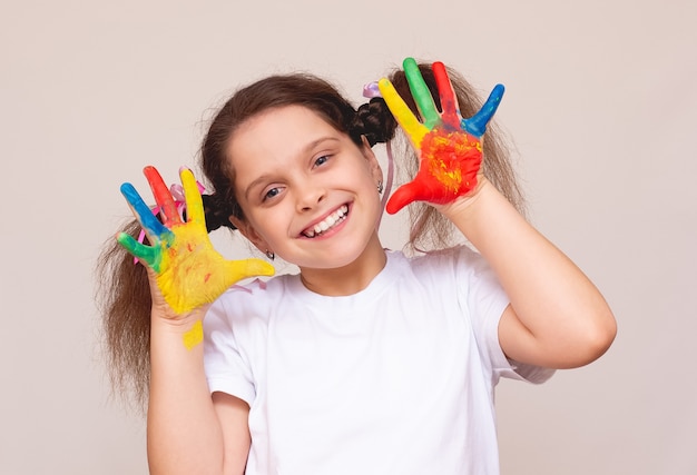 The happy cute girl with painted hands
