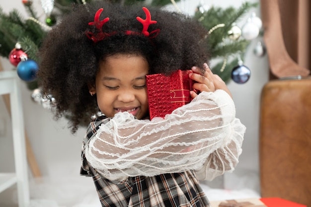 Happy cute kid girl with afro hair and Christmas decorations