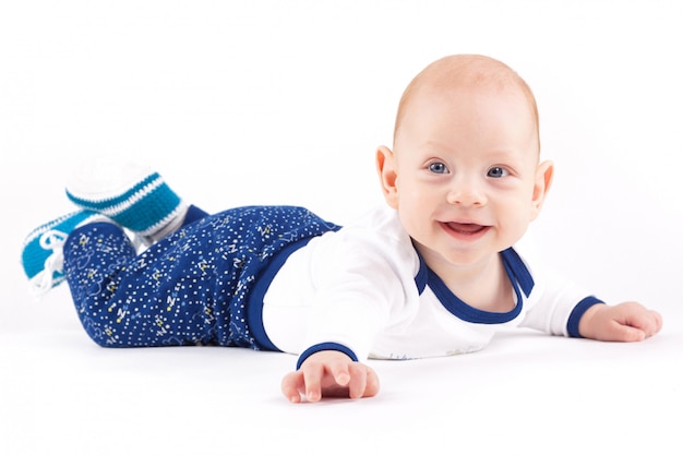 Happy cute little boy in white shirt and trousers