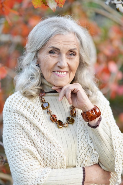 Happy cute smiling senior woman in park