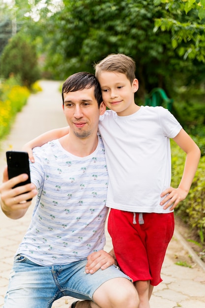 Happy dad and baby take selfies.