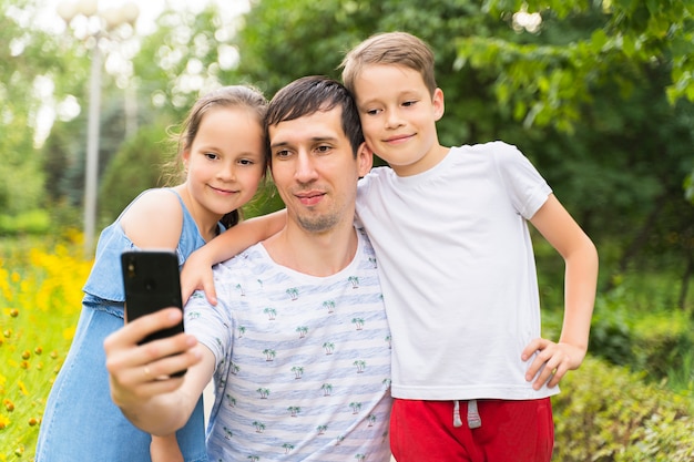 Happy dad and kids take selfies.