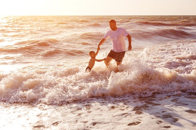 Happy dad and son swim in the sea