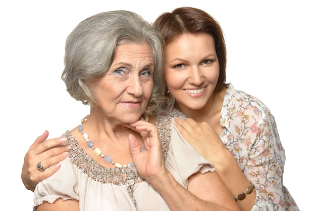 Happy daughter hugging her mother on a white background