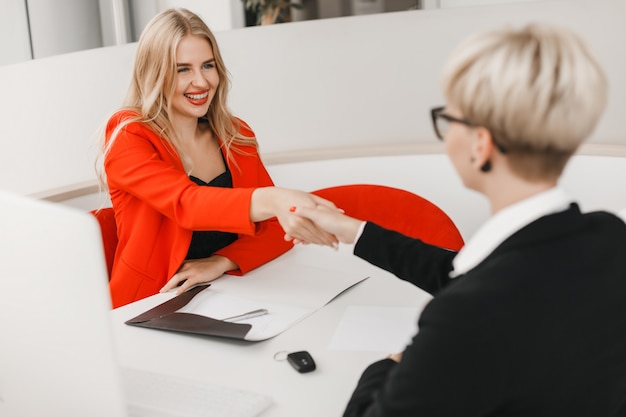 Happy  dealer shake a hand with customer after deal.