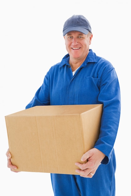 Happy delivery man holding cardboard box