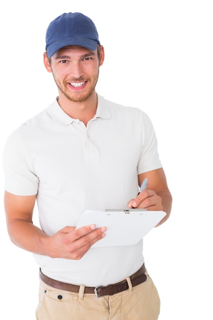 Happy delivery man holding clipboard