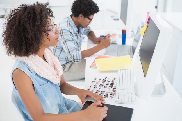 Happy design team working at desk 