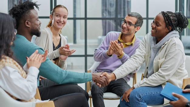 Photo happy diverse business colleagues men shaking hands with gratitude recognition respec