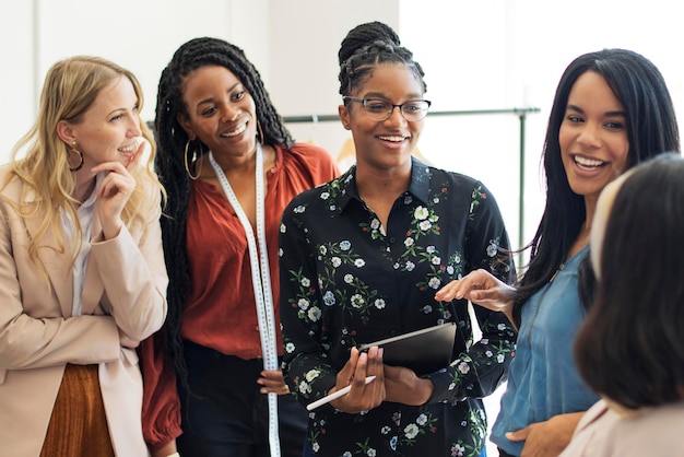 Happy diverse businesswoman using a digital tablet