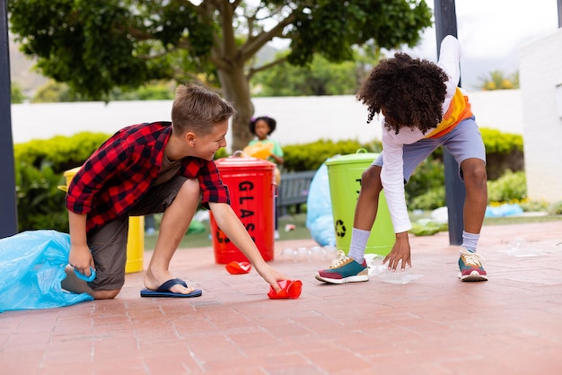 Photo happy diverse schoolchildren cleaning and recycling waste at school