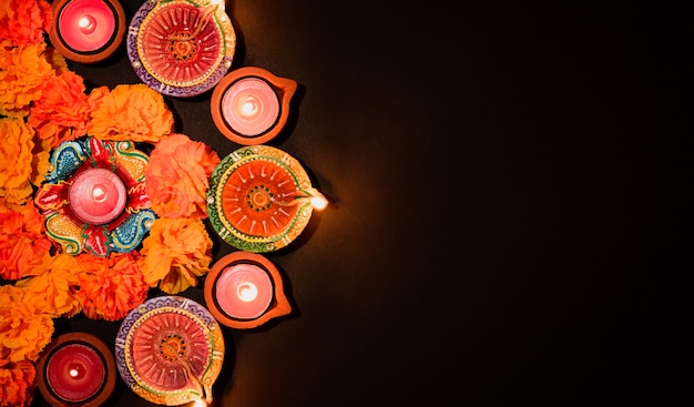 Happy Diwali  Clay Diya lamps lit during Dipavali Colorful traditional oil lamp diya