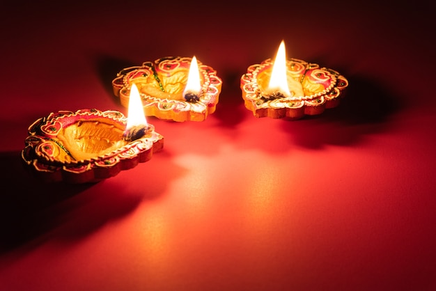 Happy Diwali - Clay Diya lamps lit during Dipavali, Hindu festival of lights celebration.