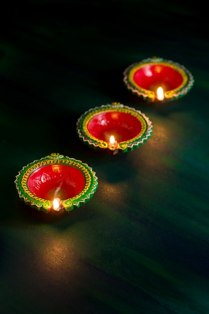 Happy Diwali - Clay Diya lamps lit during Diwali celebration. Greetings Card Design of Indian Hindu Light Festival called Diwali