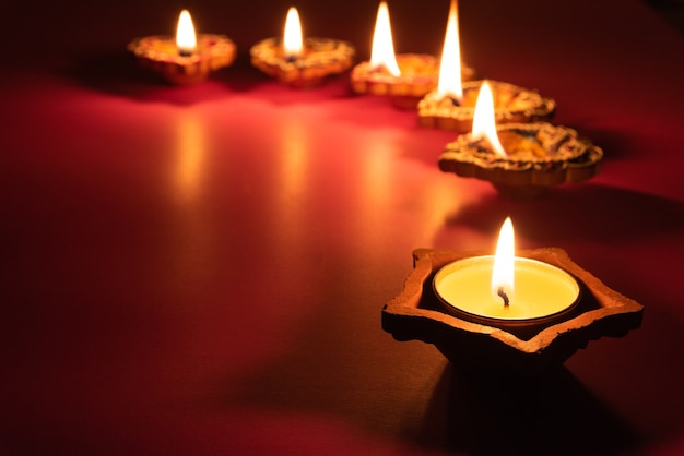 Happy diwali - clay diya lamps lit during dipavali, hindu festival of lights celebration.