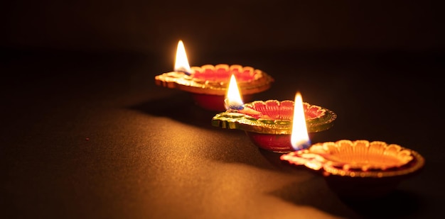 Happy Diwali Diya colorful oil lamps dark background