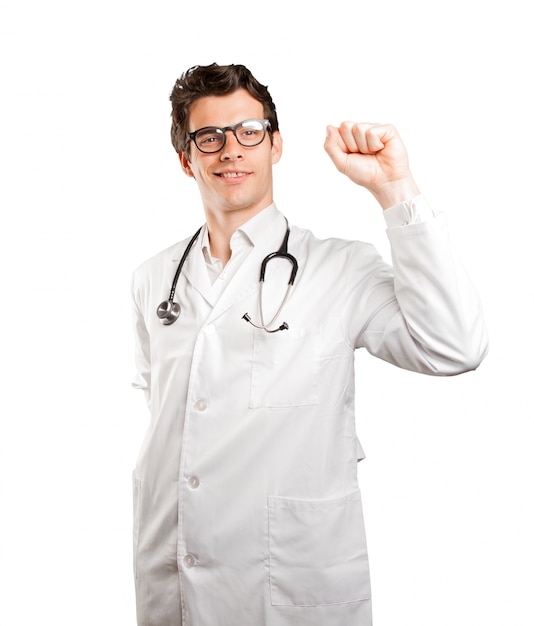 Happy doctor celebrating against white background